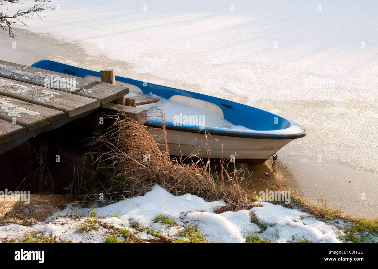boat on a frozen river Stock Photo - Alamy