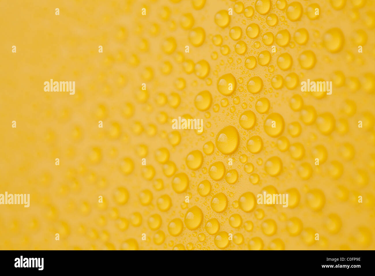 Yellow water drops background hi-res stock photography and images - Alamy