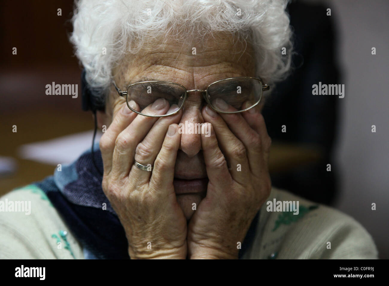 An old woman wipes away tears as she cry Stock Photo