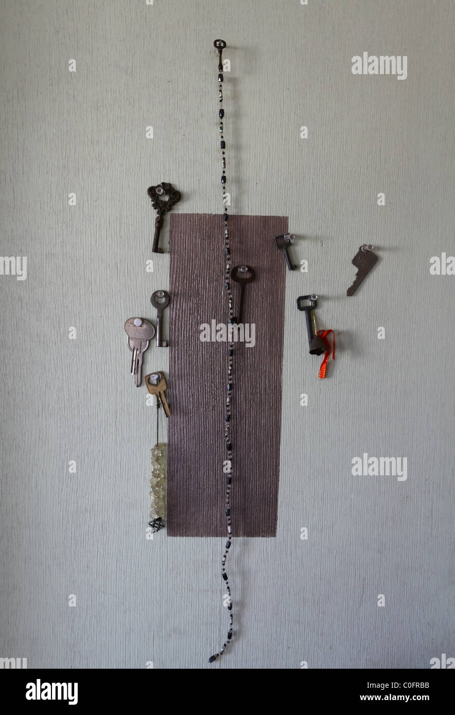 Old keys hanged in a wall Stock Photo