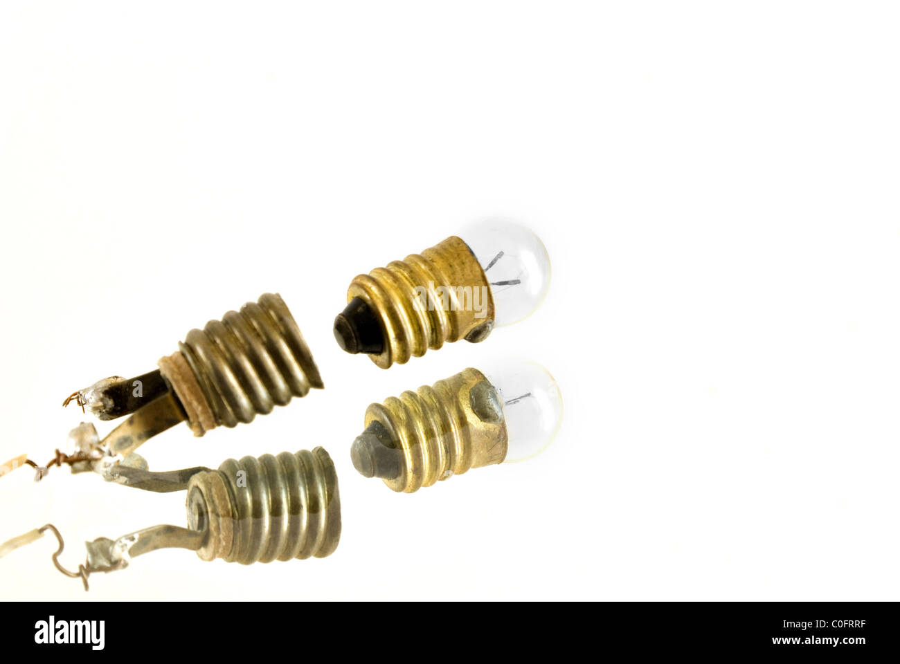 The photography of broken bulb on the white background. Taken on 2011. Stock Photo
