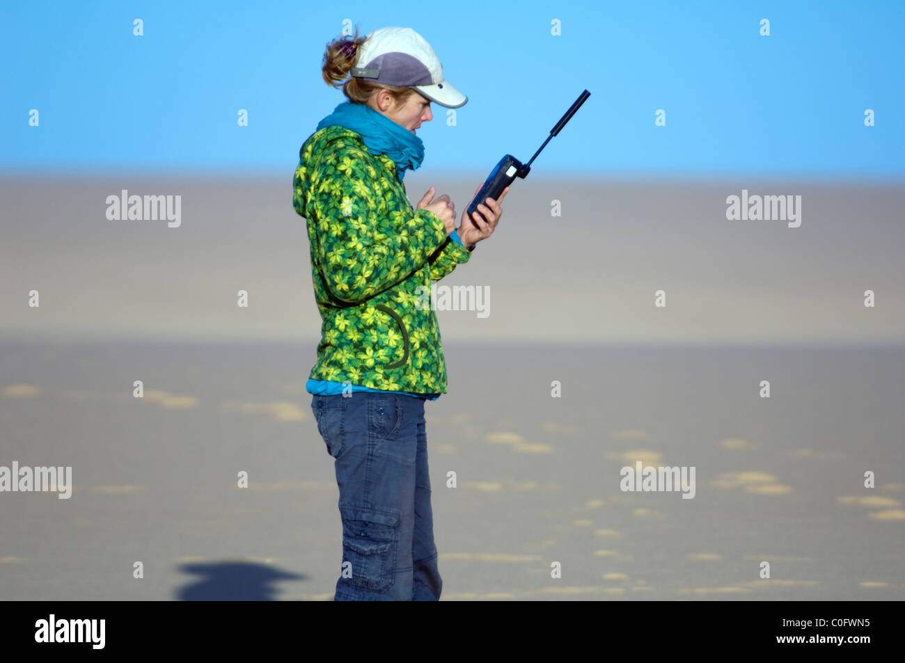 Woman holding satellite phone Sahara Desert Western Egypt Stock Photo