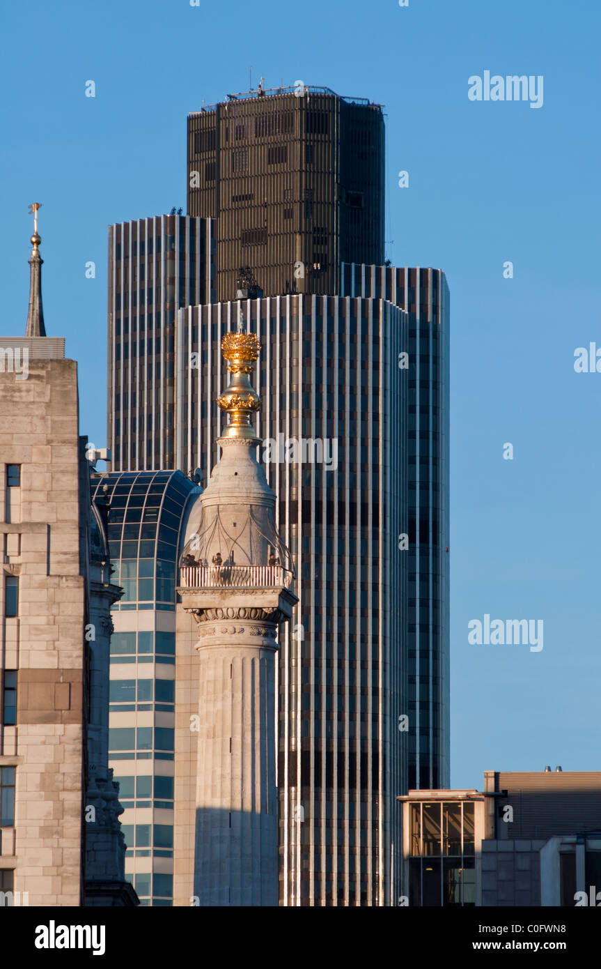 The monument in the foreground with Tower 42 (formally the Natwest tower) to the rear in the city of London. England. Stock Photo