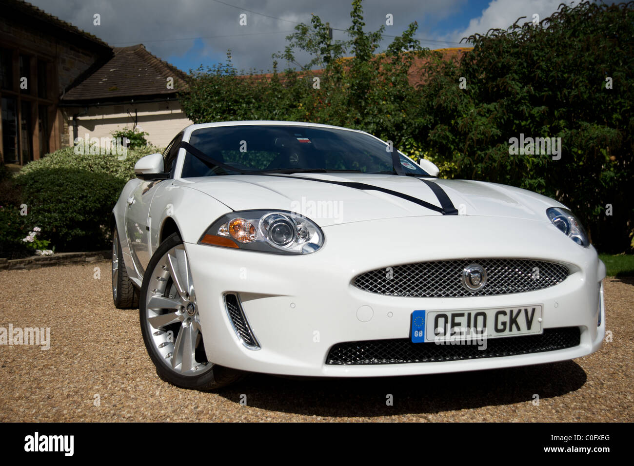 A white jaguar car outside a wedding reception, England, UK Stock Photo