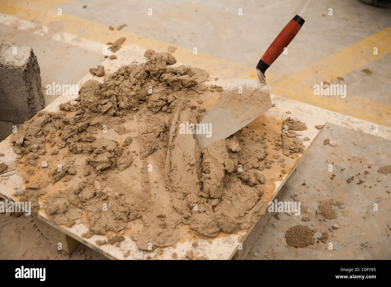 A trowel in a pile of cement, UK Stock Photo