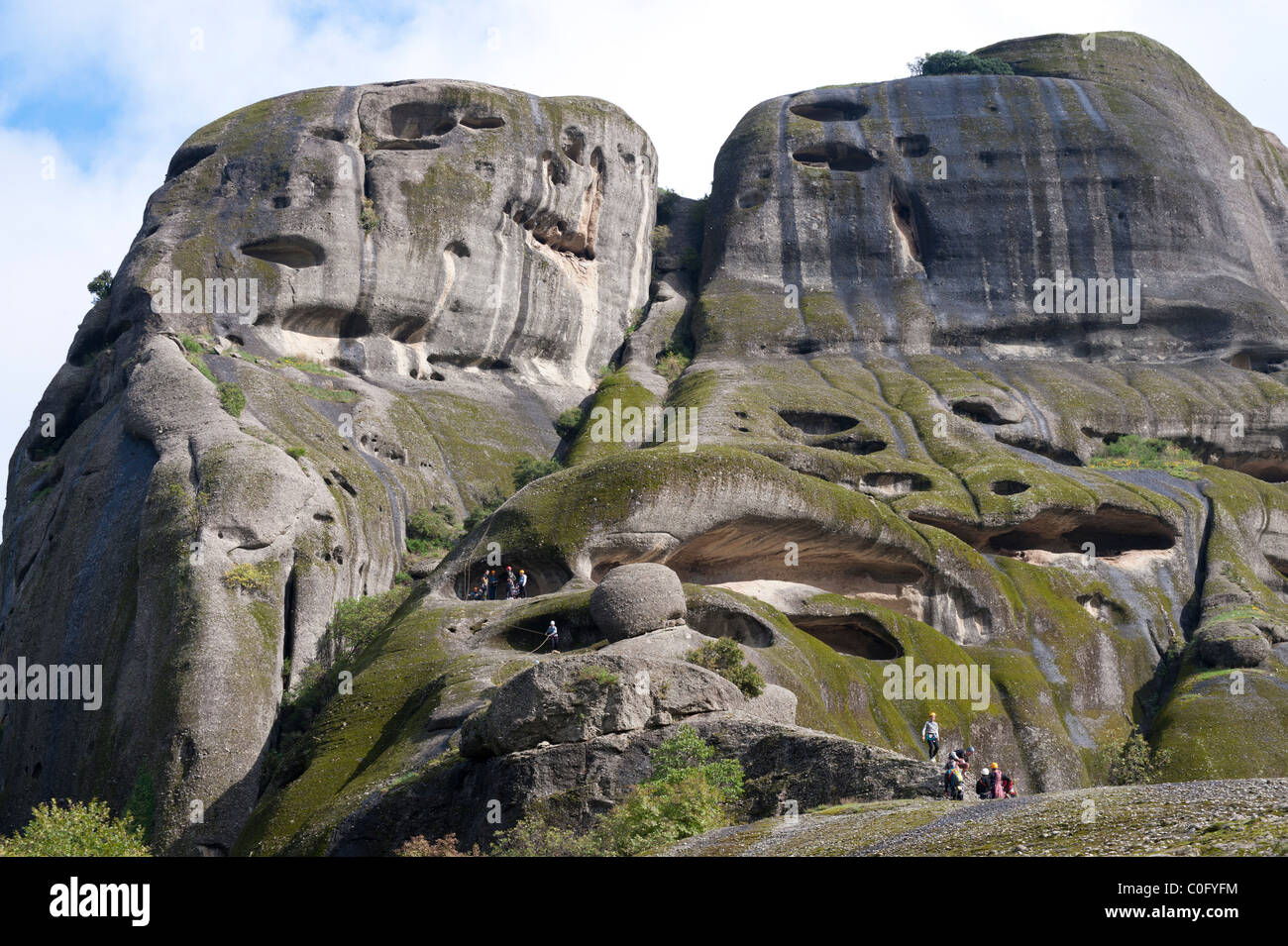 Group of climbers on a spectacular rock formation in the Meteora region, Greece. Stock Photo