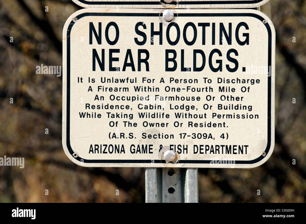 A sign warns about discharging firearms in Brown Canyon in the Sonoran Desert, Arizona, USA. Stock Photo