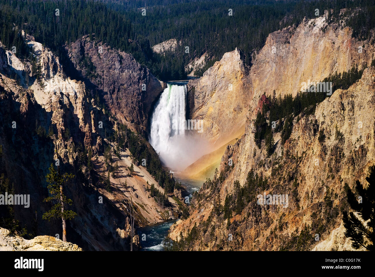 Horizontal view of a rainbow that forms every morning under Yellowstone falls viewed from Artist Point Stock Photo
