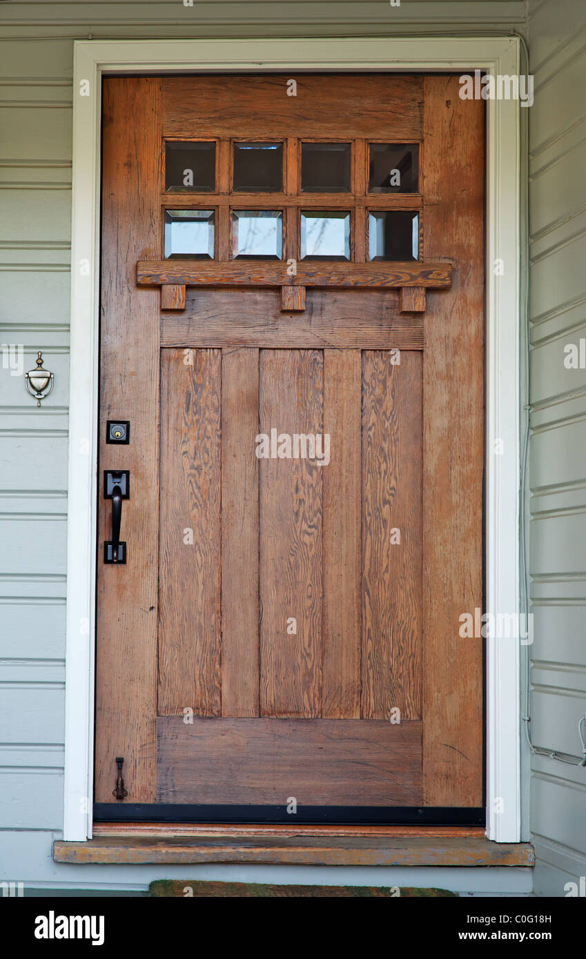 Weathered Mission style Wood door with beveled glass windows on California Bungalow Stock Photo