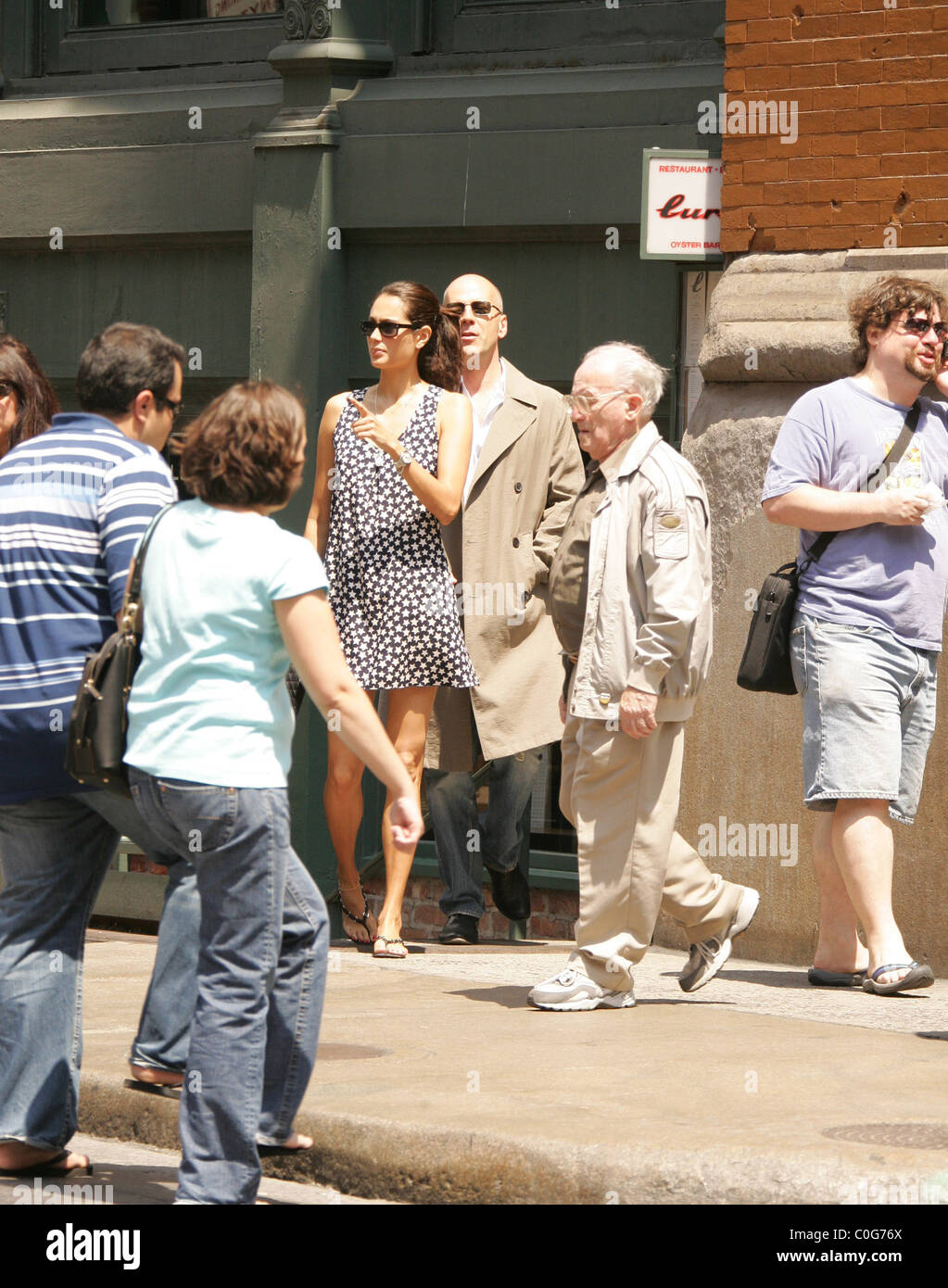Bruce Willis wearing an old mackintosh rain coat and his british model ...