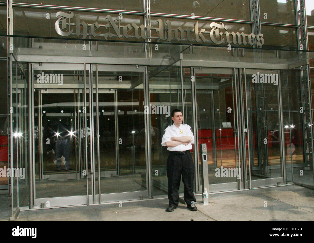 A security guard stands in front of the New York Times building to
