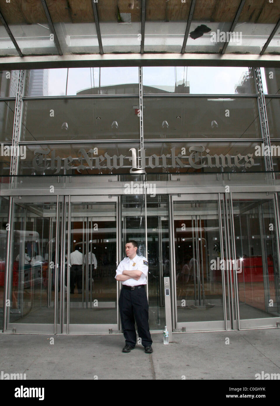 A security guard stands in front of the New York Times building to ensure that no copycat protestors try to scale the building Stock Photo