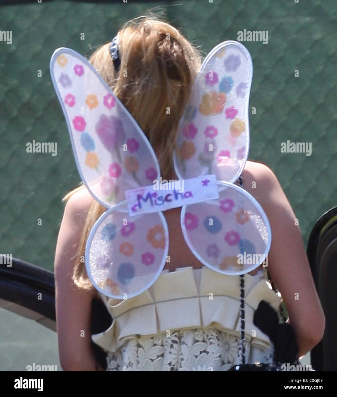 Mischa Barton couldn't fly in her pink butterfly wings as she left the Hero Awards with her mother, and stepped into some dog Stock Photo