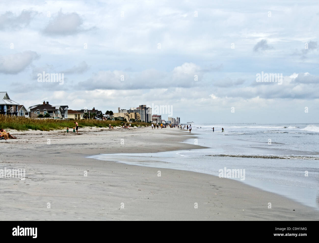 beach tranquil scene ocean water sand tourists tourism Jacksonville waves buildings high-rise relaxation retirement Stock Photo