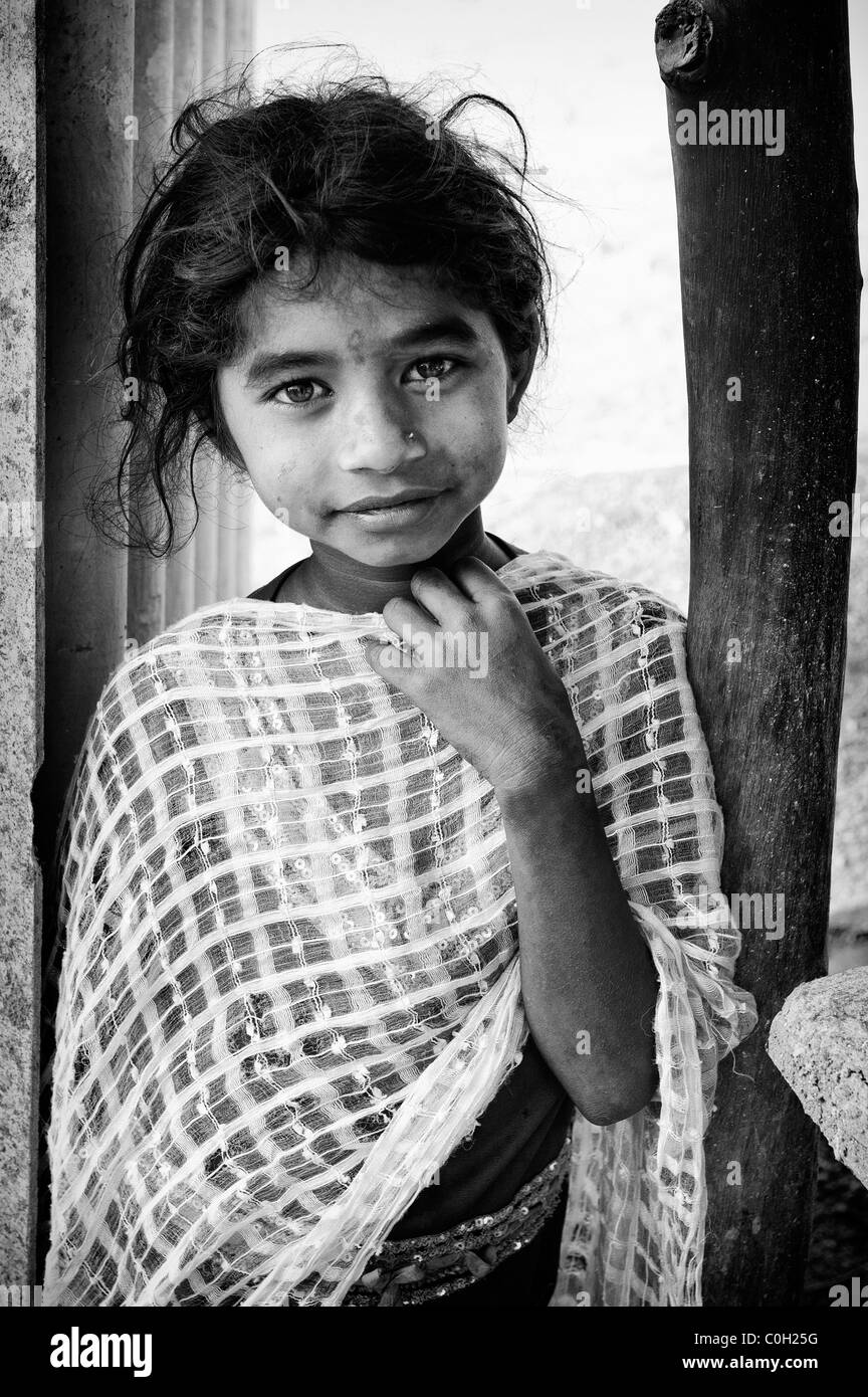 Happy poor lower caste Indian street girl smiling. Andhra Pradesh, India. Black and White. Stock Photo