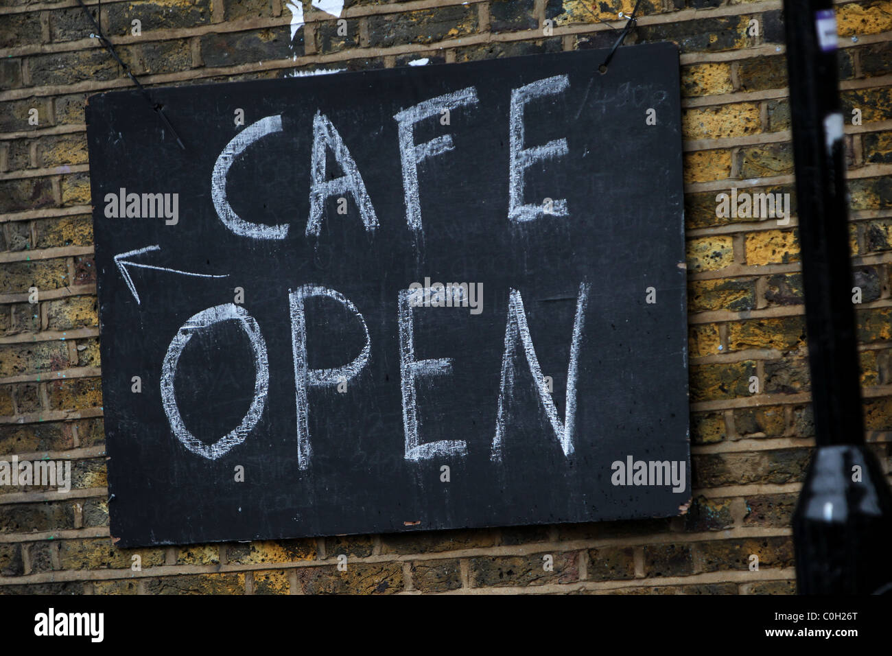 Cafe open sign on the side of a building in London Stock Photo Alamy