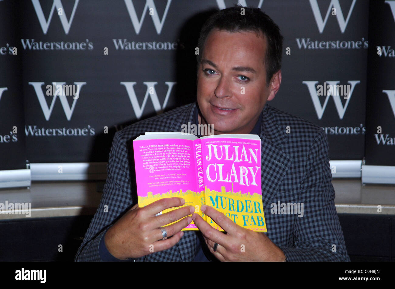 Julian Clary signing copies of his debut novel 'Murder Most Fab' at