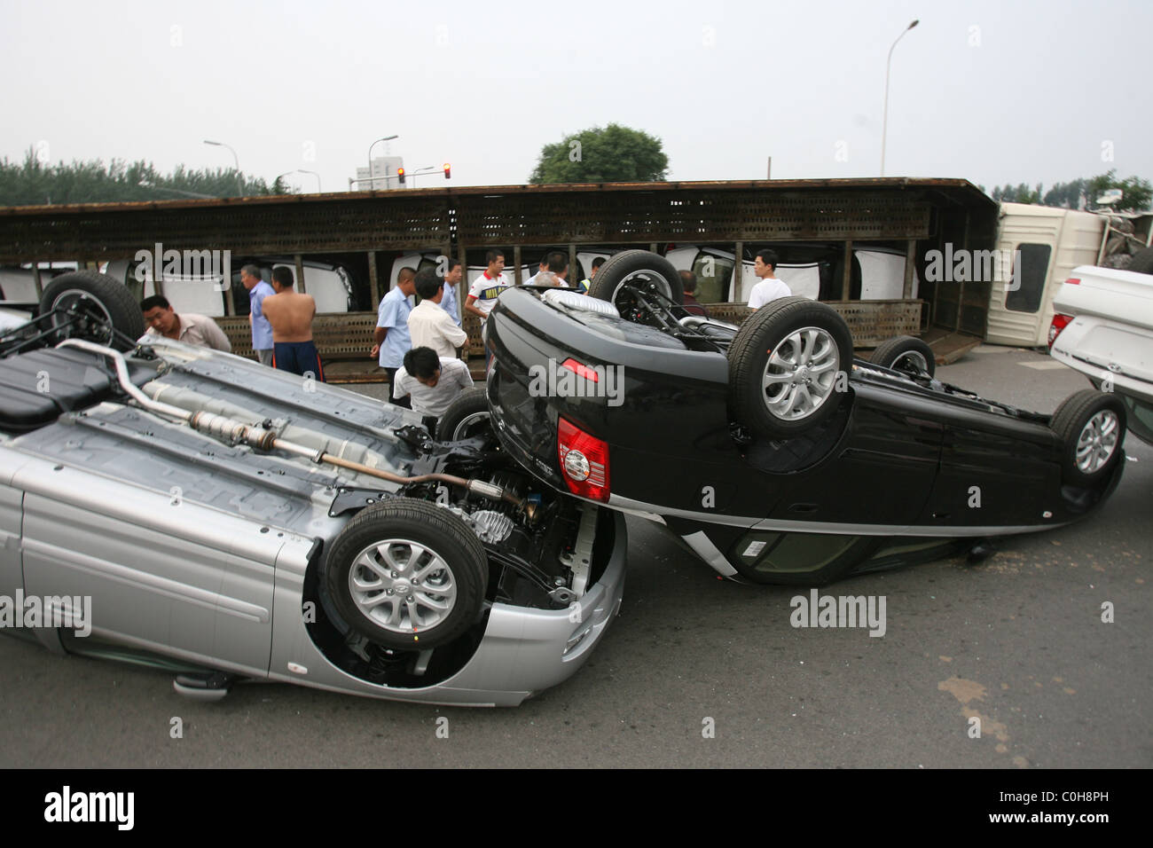 CAR CARRIER FLIPS ON JUNCTION A haulage truck carrying a fleet of brand