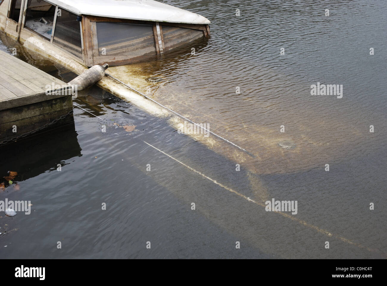 Sunken boat. Boat swamped and sunk in water at mooring Stock Photo Alamy