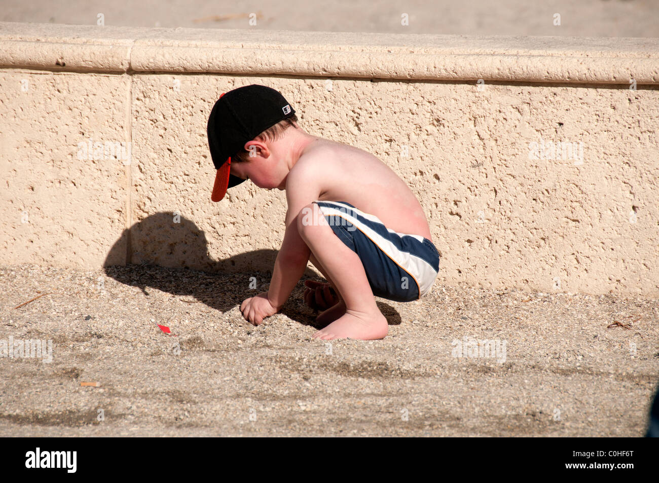 Little boy playing in sand. Stock Photo