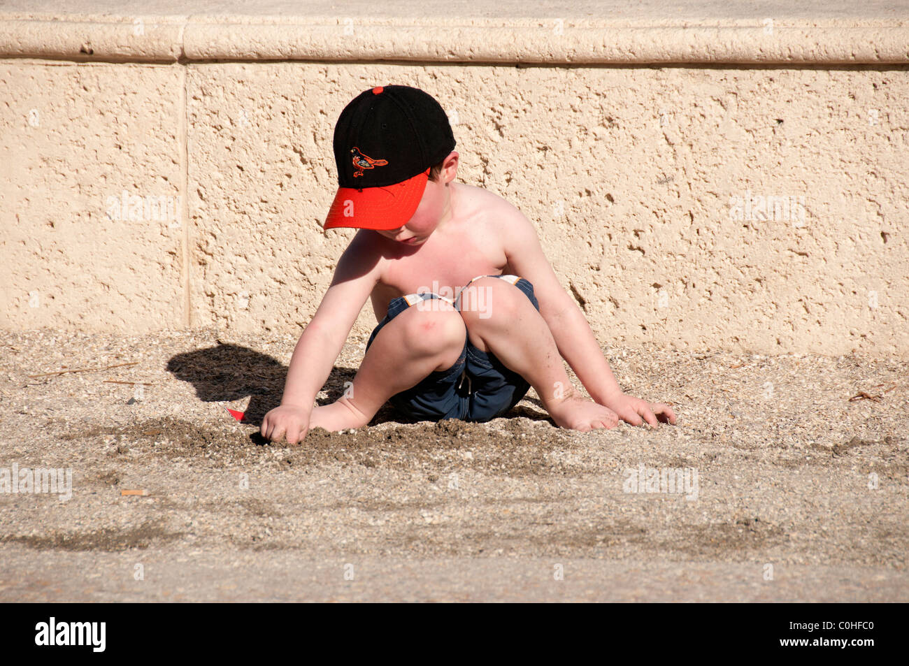 Little boy playing in sand. Stock Photo