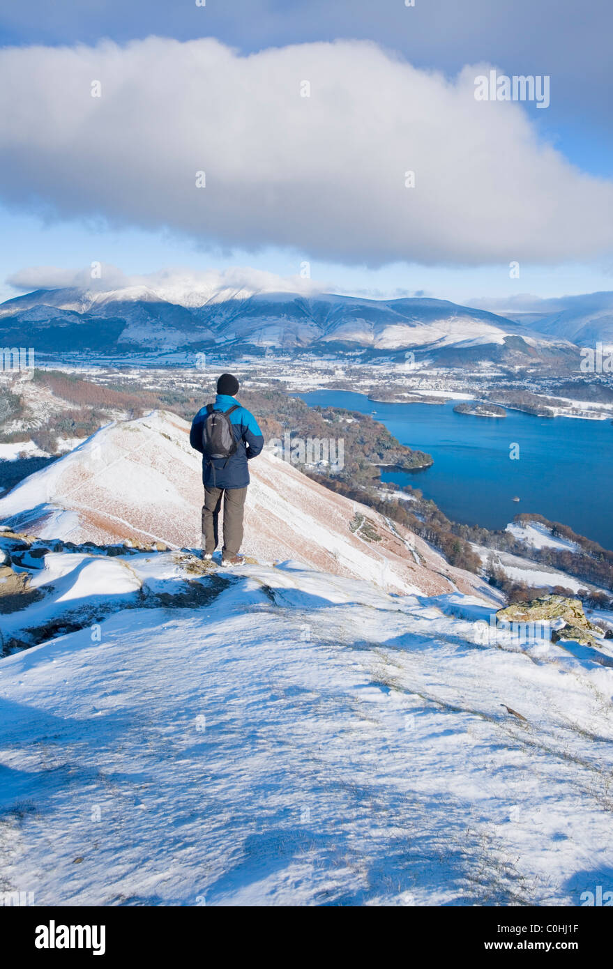 Caucasian Male Walker on Cat Bells looking towards Derwent Water and Skiddaw. Lake District National Park. Cumbria. England. UK. Stock Photo