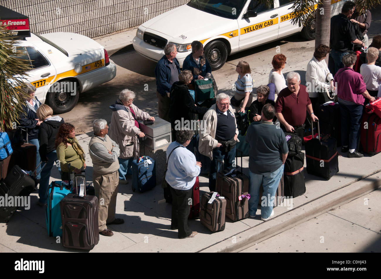 Arrived passengers waiting for ground transportation. Stock Photo