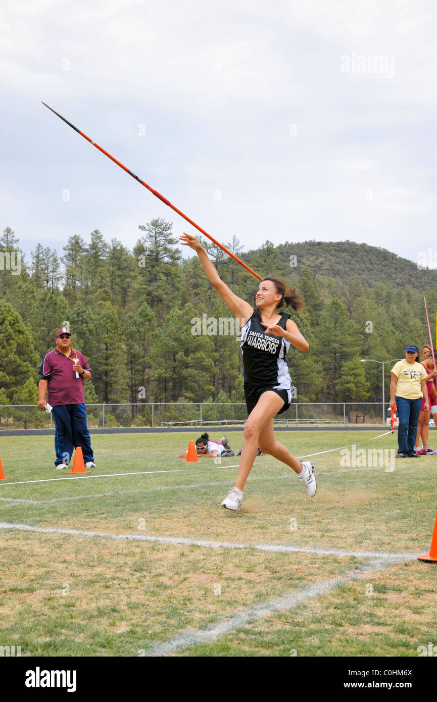 Teenage high school girl athlete participates in the javelin throw