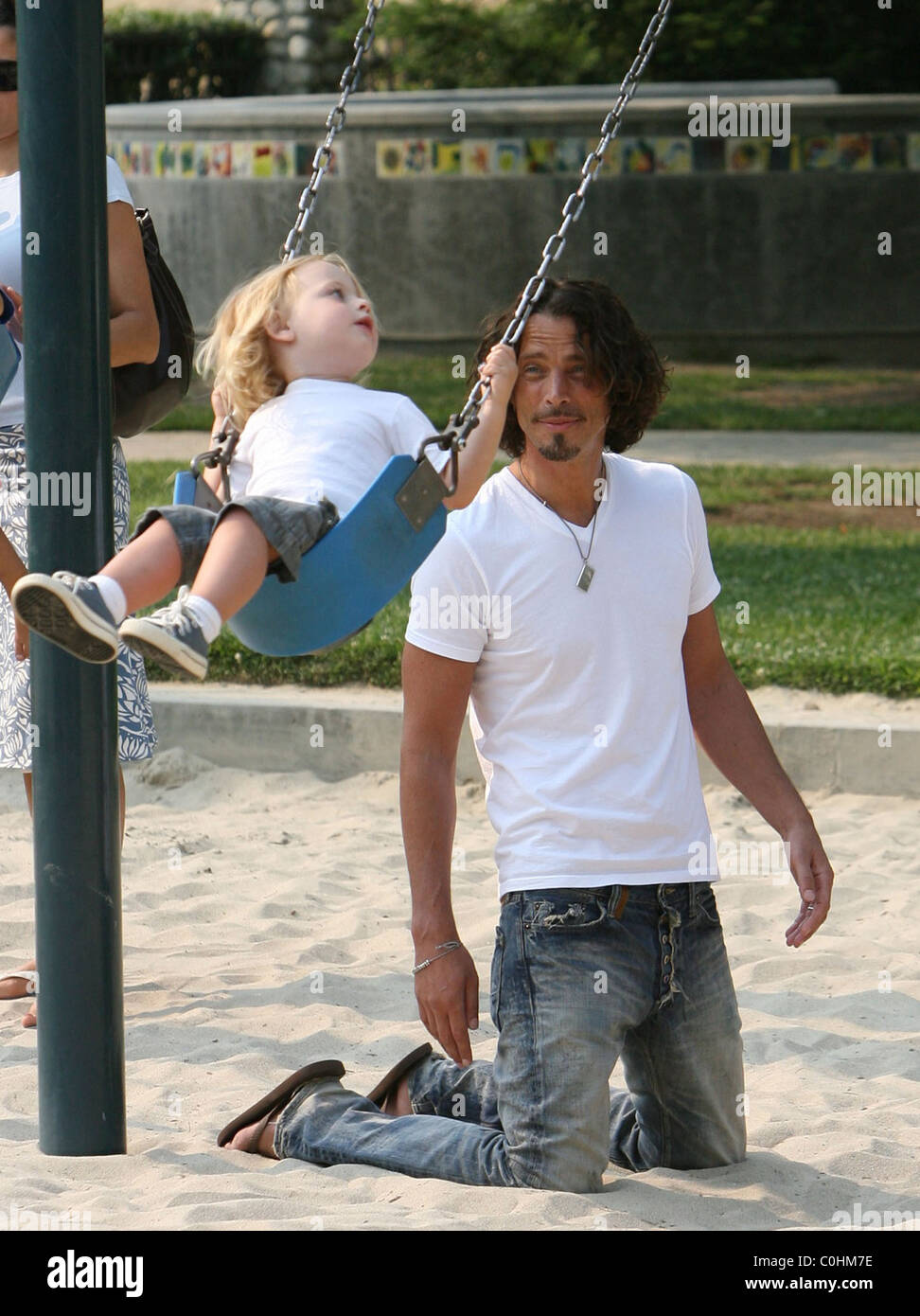 Chris Cornell and his son Christopher playing on the swings as the musician spent some quality time with his two young children Stock Photo