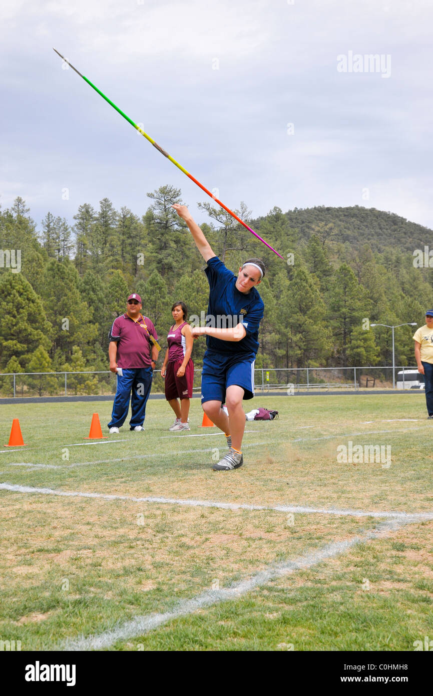 Teenage high school girl athlete participates in the javelin throw