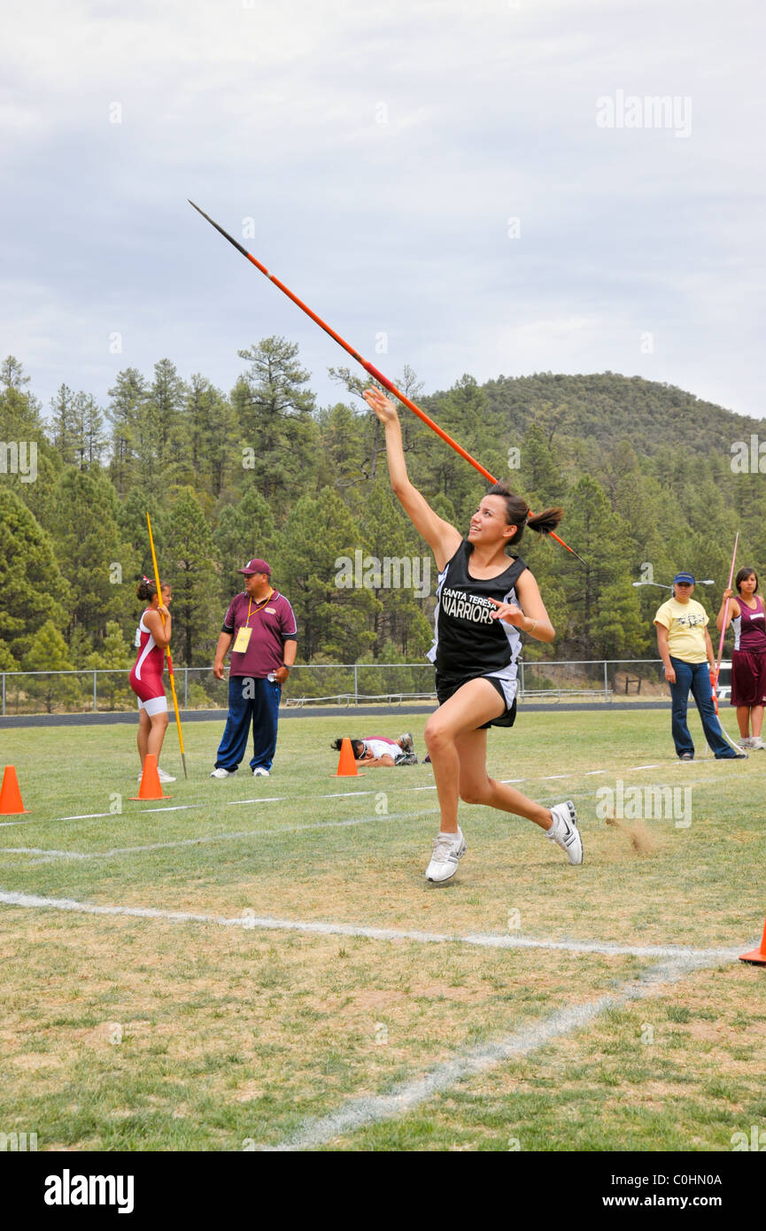 Teenage high school girl athlete participates in the javelin throw