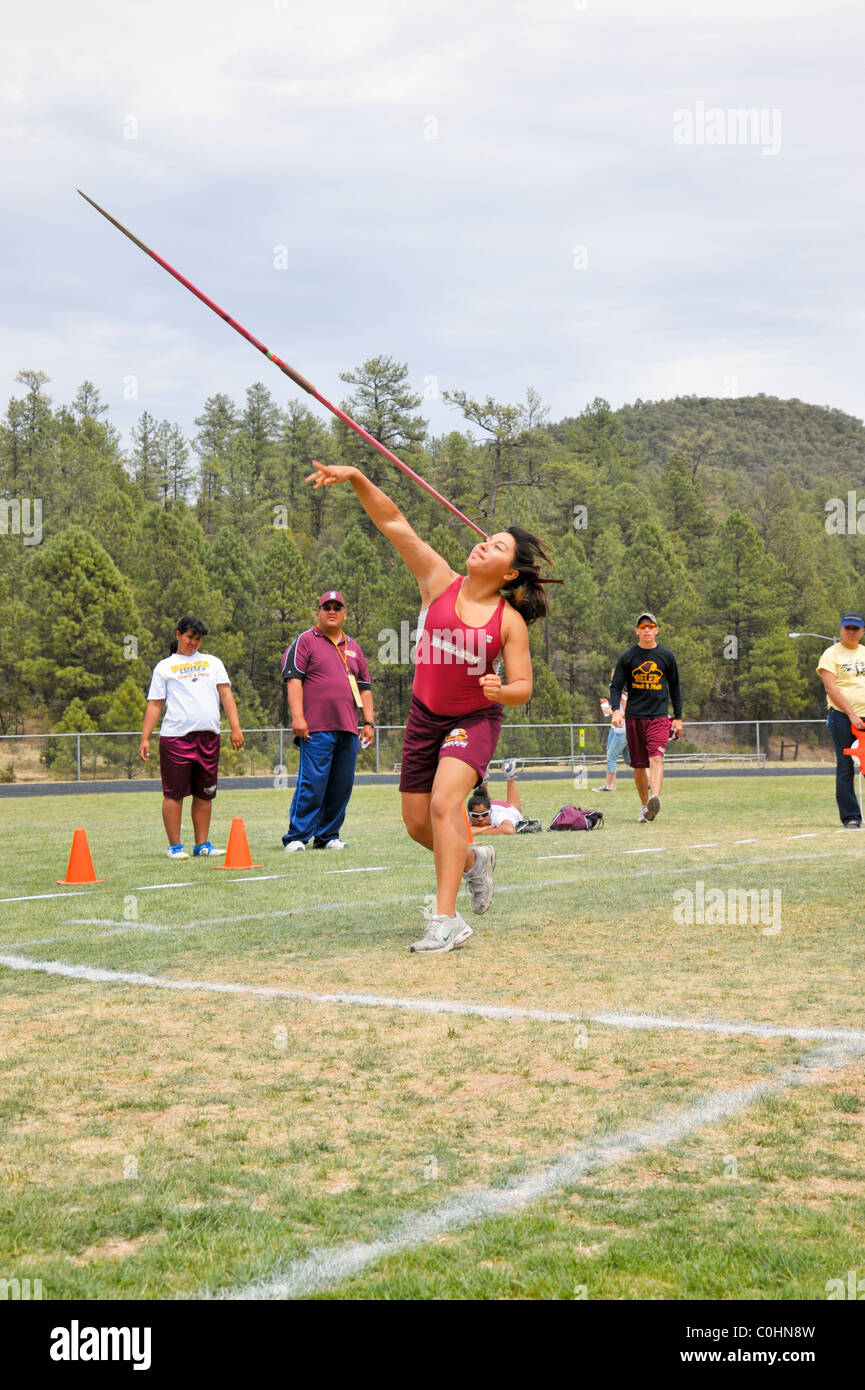 Teenage high school girl athlete participates in the javelin throw