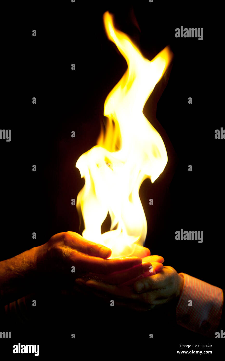 Men's hands holding flames Stock Photo Alamy