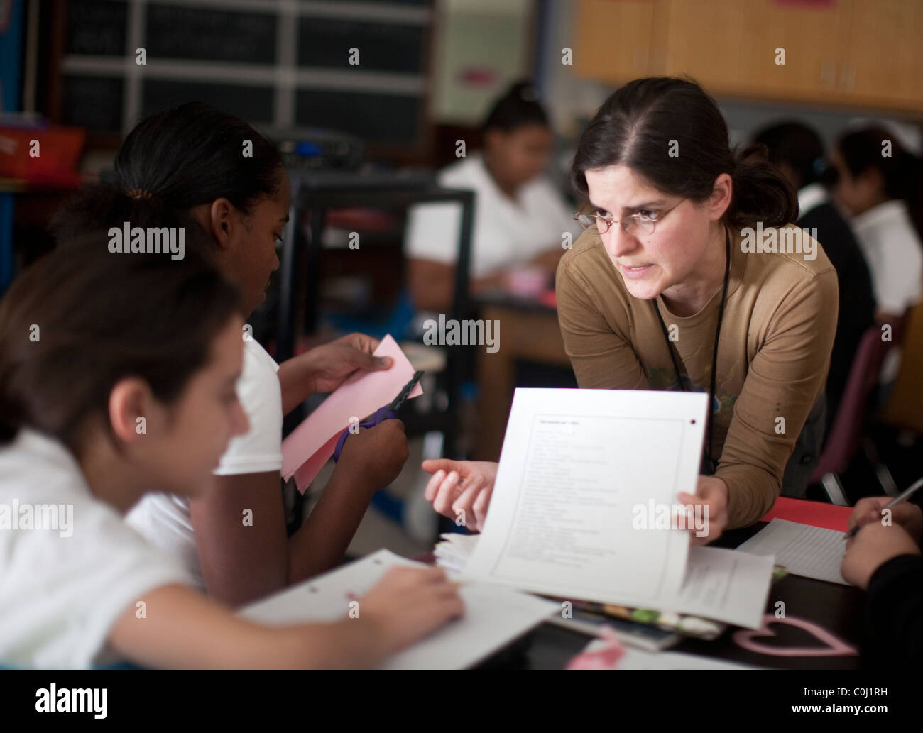 Teacher discusses classwork with student at all-girls Ann Richards School for Young Women  Leaders in Austin Texas Stock Photo