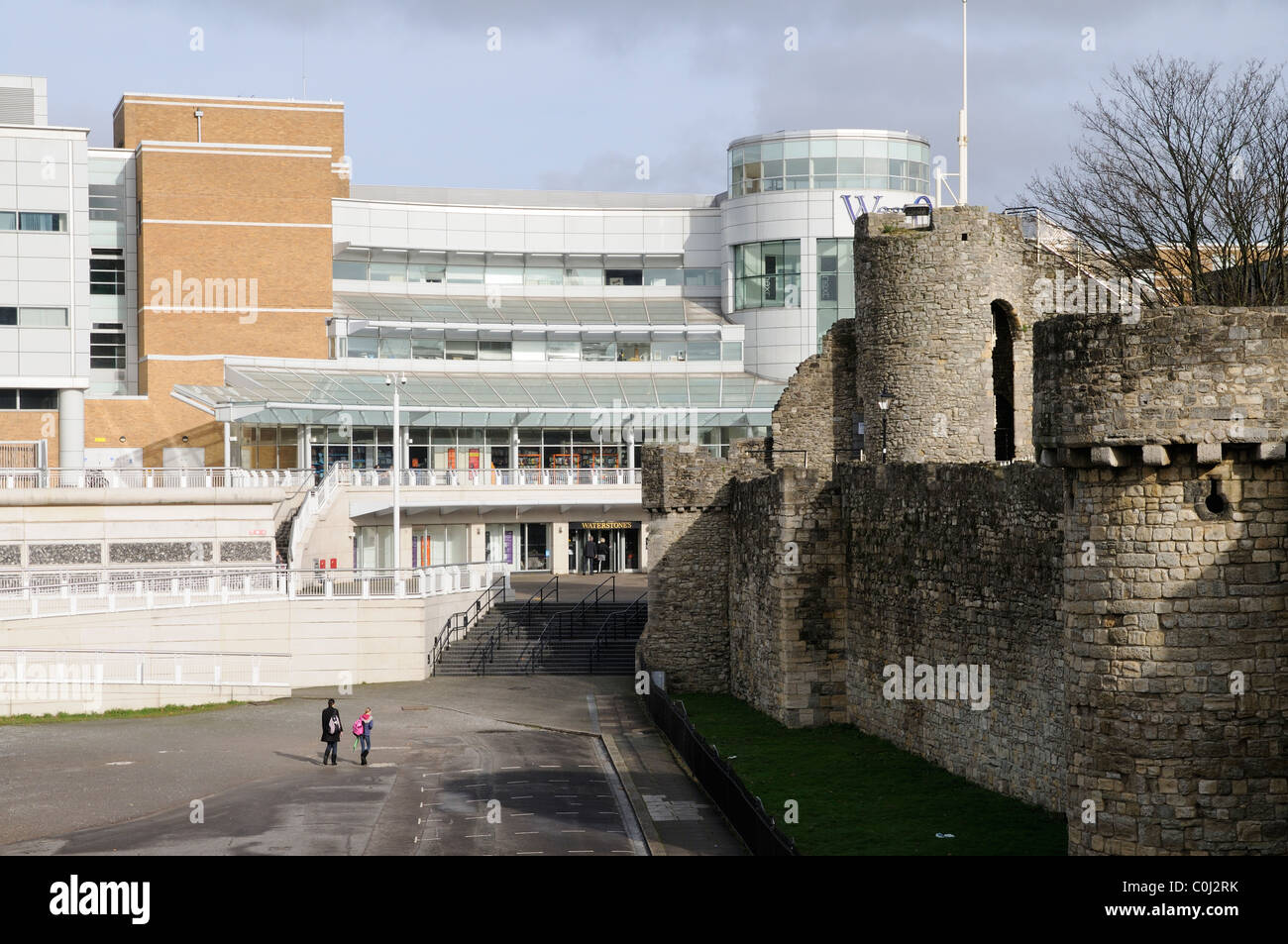 Old and new the modern West Quay shopping complex and the medieval town walls in Southampton southern England UK Stock Photo