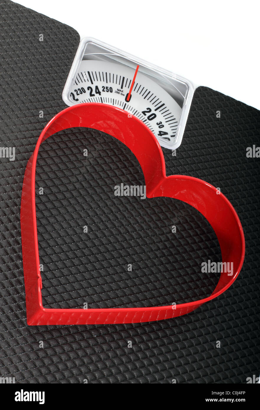 Bathroom Scales With A Red Heart Shaped Symbol For A Concept On Healthy Lifestyle Stock Photo
