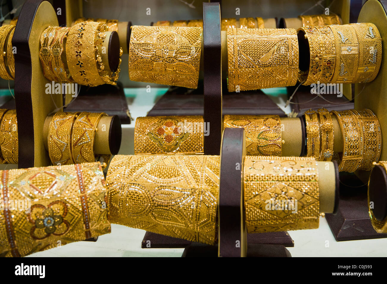 Gold jewellery lined up in a shop window, Gold Souk, Deira, Dubai, United Arab Emirates Stock Photo