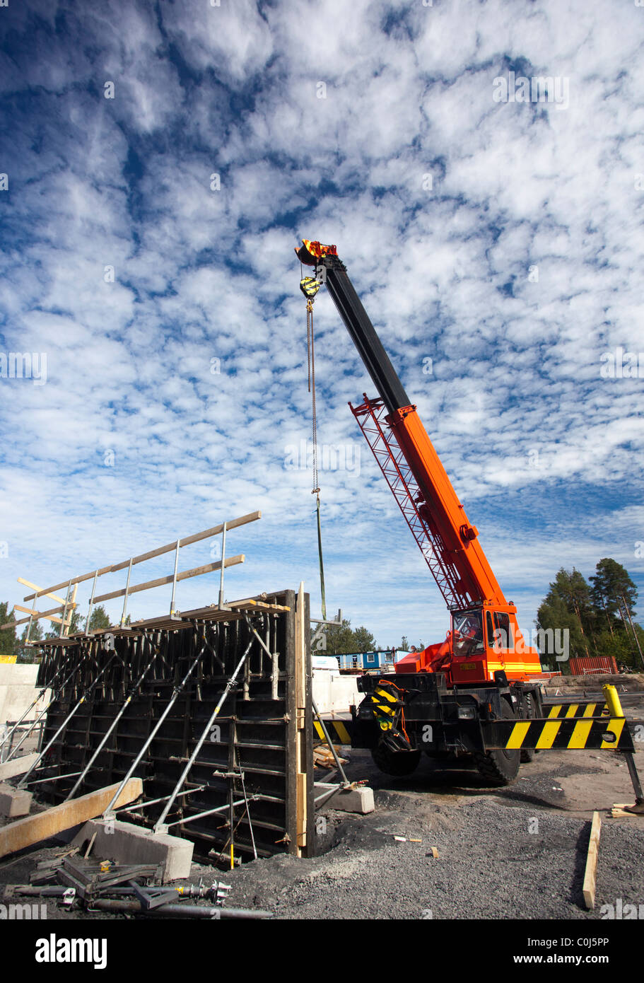 Lokomo ( MS 335 N ?? ) boom crane at construction site and concrete construction element , Finland Stock Photo