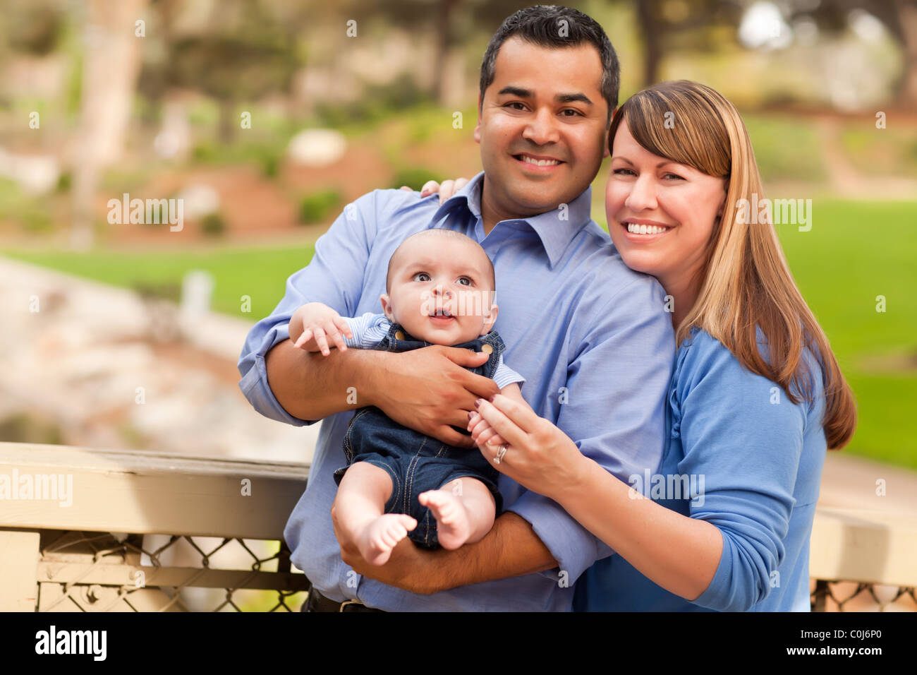 Happy Mixed Race Family Posing for A Portrait in the Park Stock Photo ...