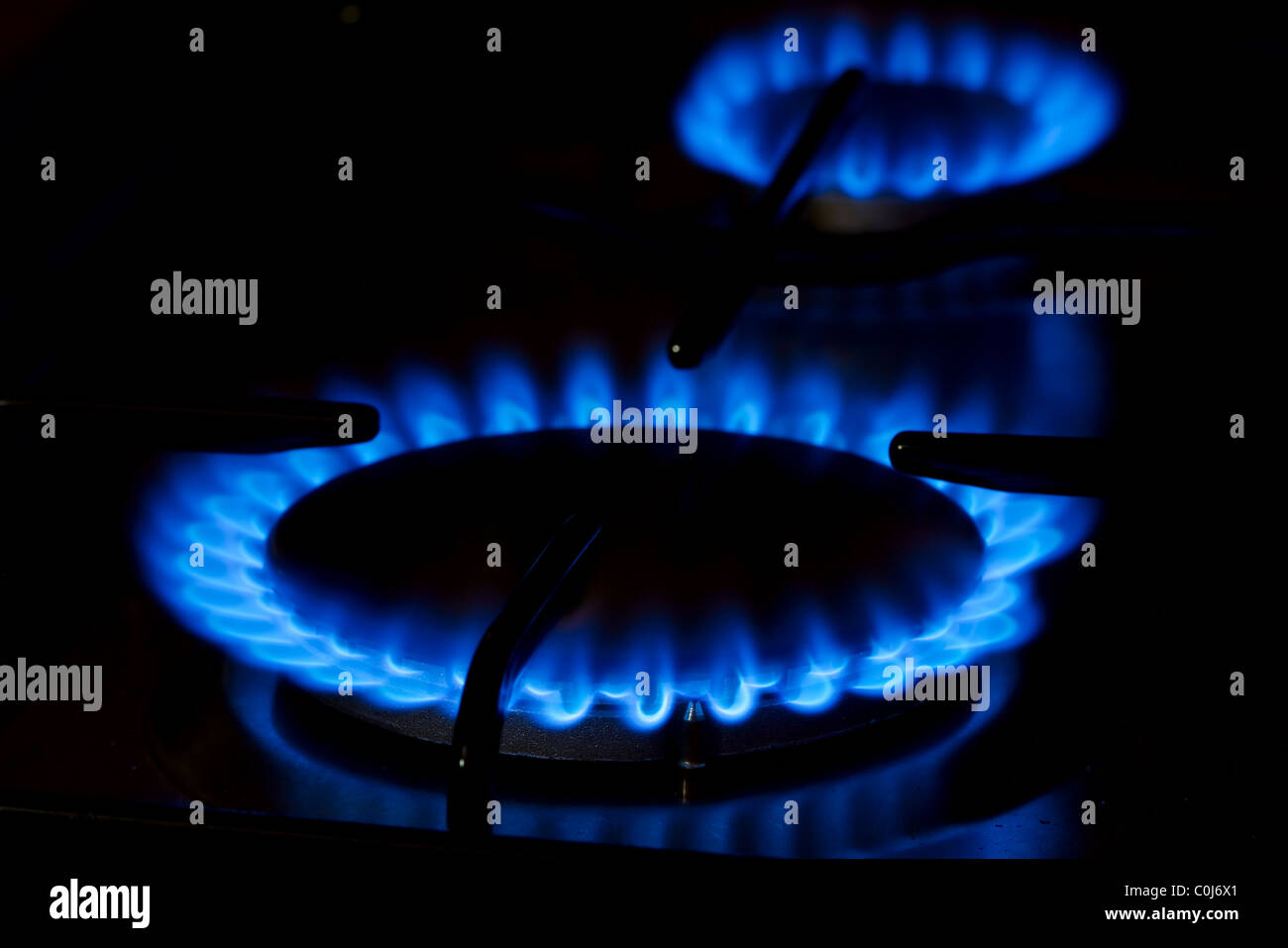 Blue gas flame of on oven in the dark Stock Photo