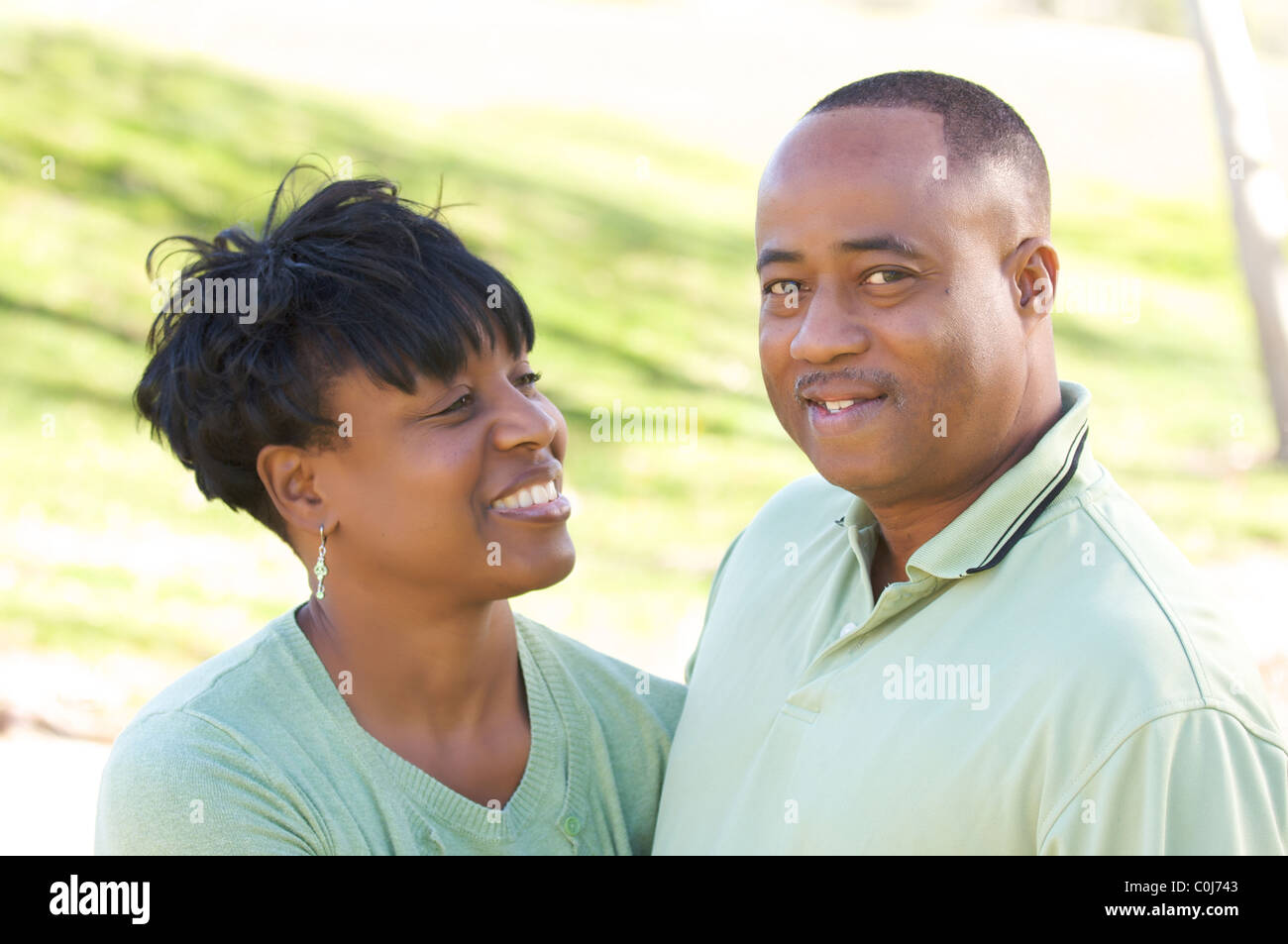 Happy African American Couple posing in the park Stock Photo - Alamy