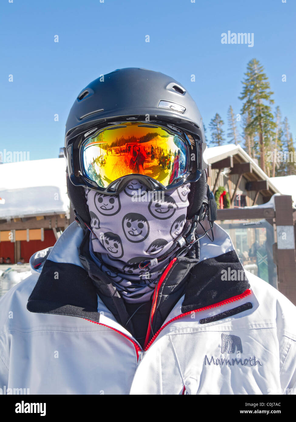Skier dressed for the cold with reflective goggle and kerchief across his face, Mammoth Mountain ski resort, California, USA. Stock Photo