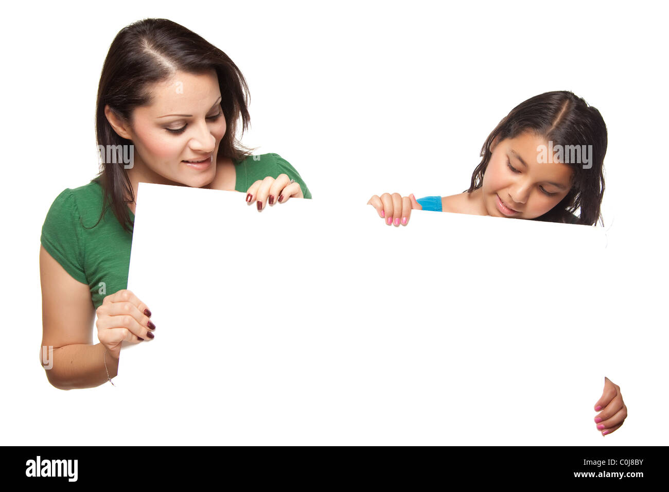 Hispanic Girl and Mother Holding Blank Board Isolated on a White Background. Stock Photo