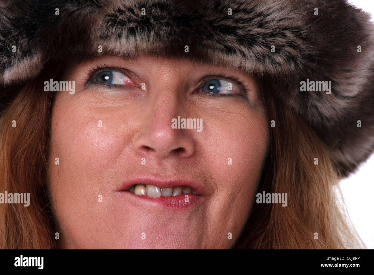 Older woman wearing fur hat Stock Photo