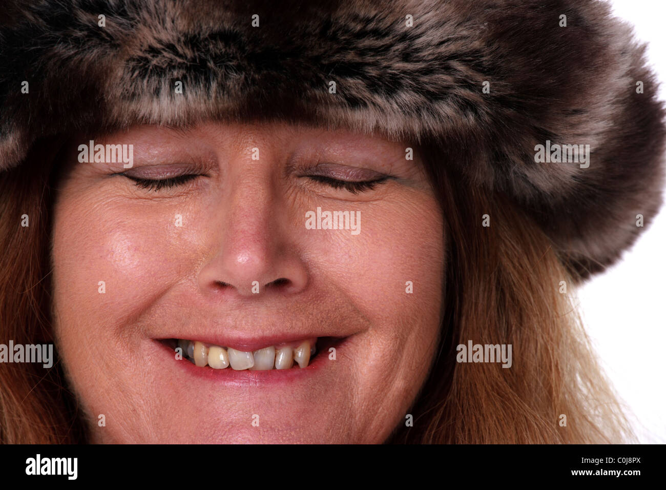 Older woman wearing fur hat Stock Photo
