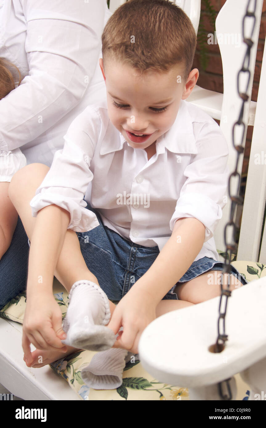 Kid putting on socks hires stock photography and images Alamy