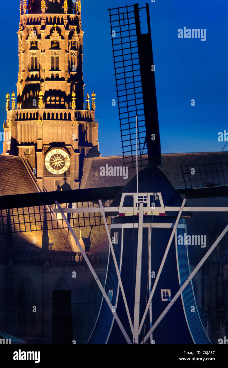 Haarlem landmarks Windmill De Adriaan and the Grote (Great) or Oude (Old) St Bavo church, cathedral and bell tower at dusk. Stock Photo