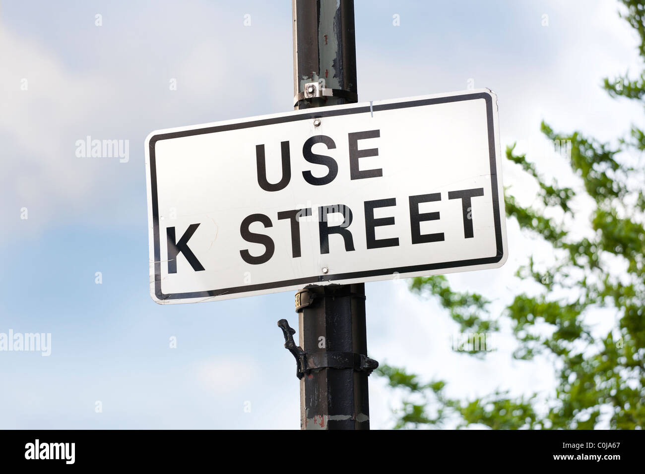 A street sign in Washington D.C. reading: Use K Street. K Street is a metaphor, figure of speech, for the US lobbying industry. Stock Photo