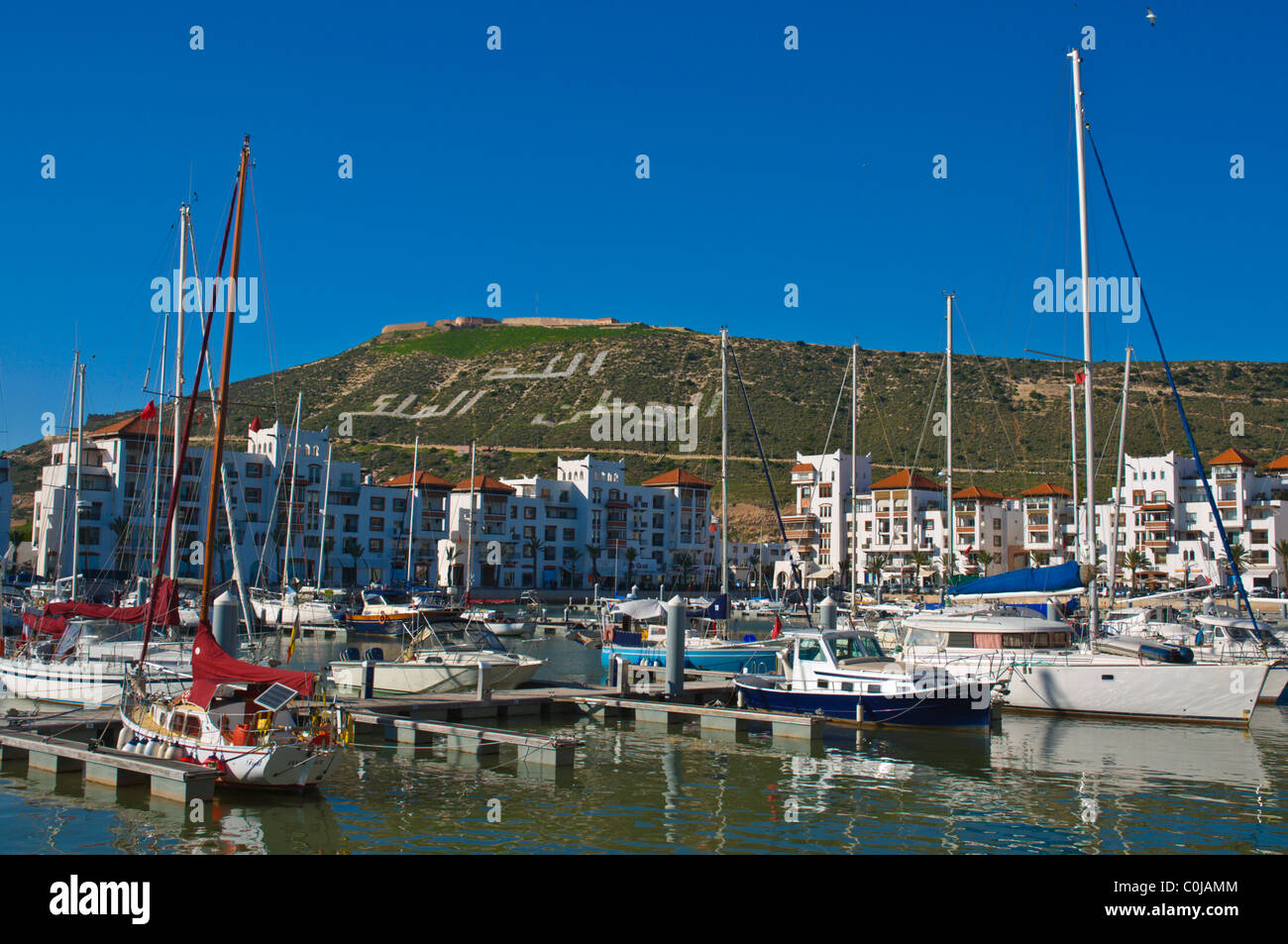 Boats moored at Marina port area with Kasbah in background Agadir the Souss  southern Morocco Africa Stock Photo - Alamy