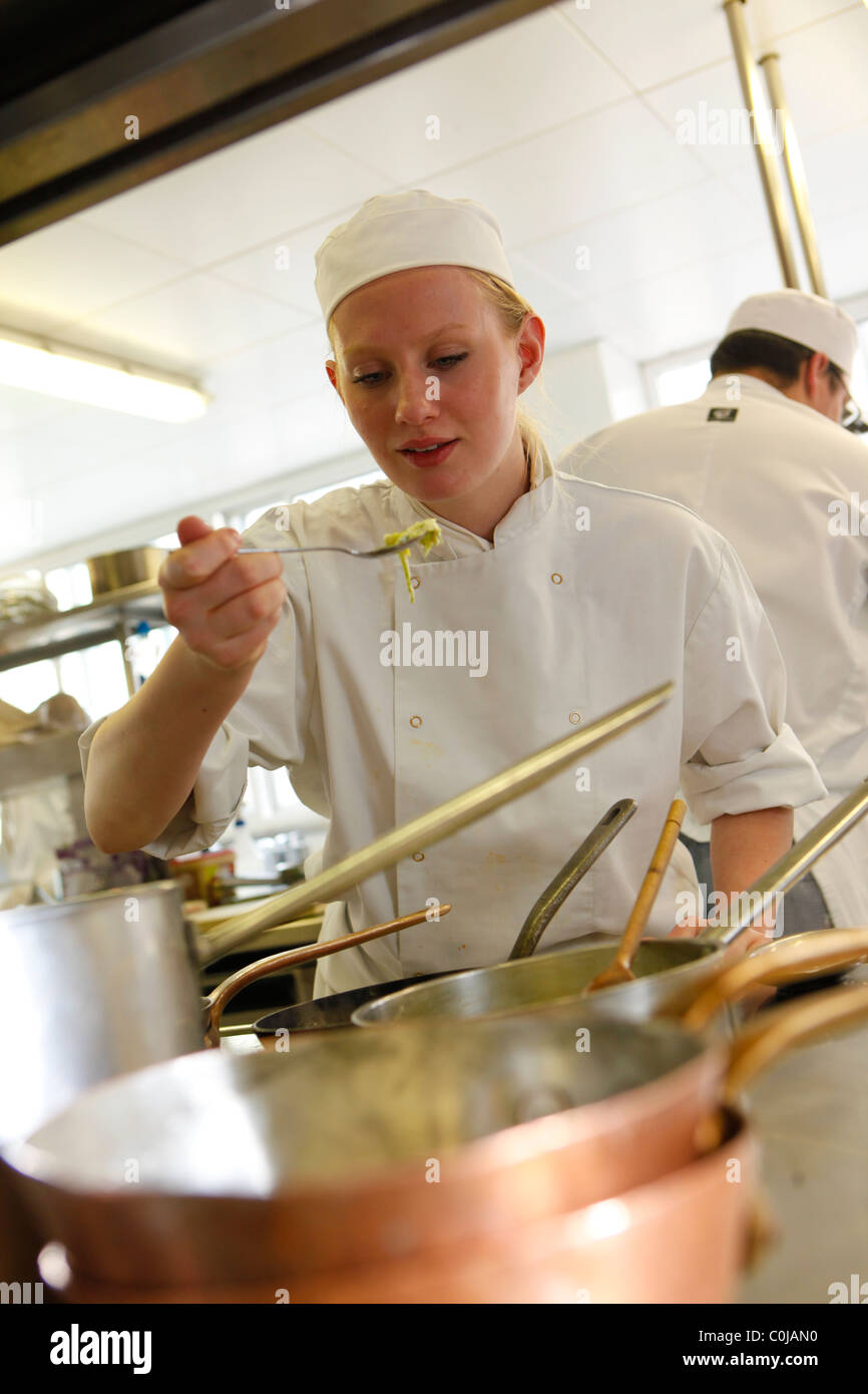 Chefs in a kitchen preparing food at a college for further and higher education Stock Photo